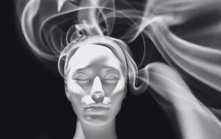 A classical plaster head surrounded by swirling smoke.