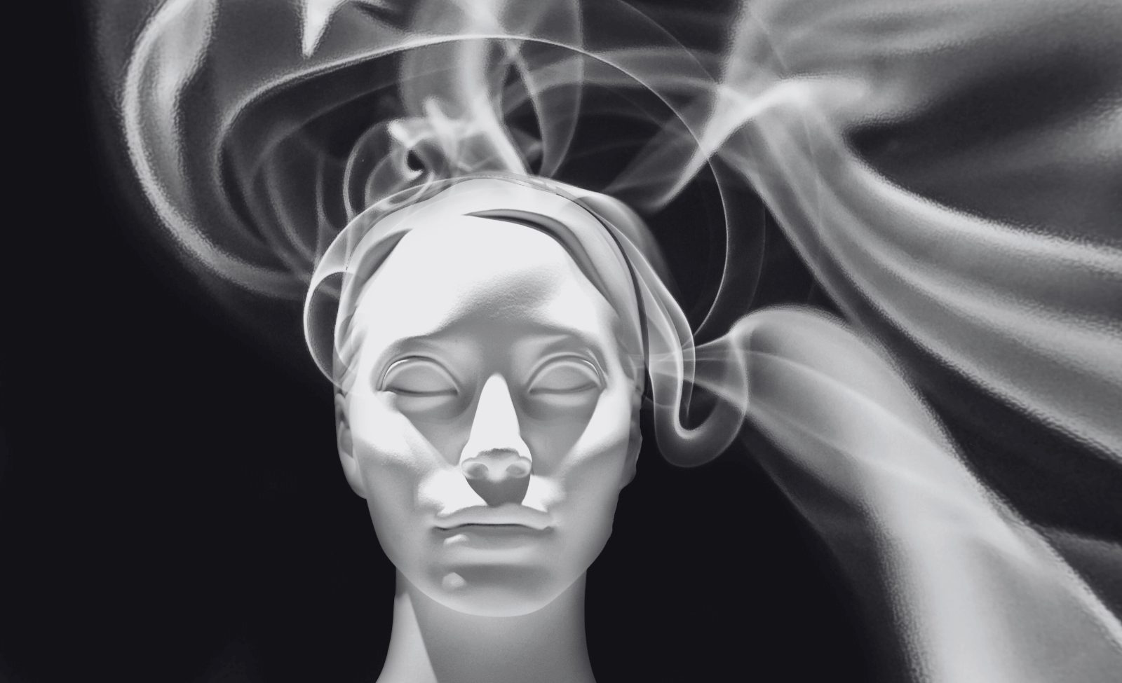 A classical plaster head surrounded by swirling smoke.