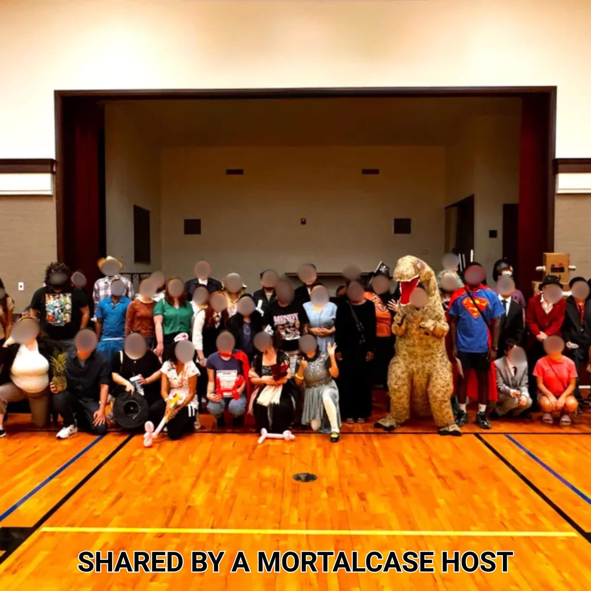 Large group of costumed guests posing after a Murder Among Monsters party.
