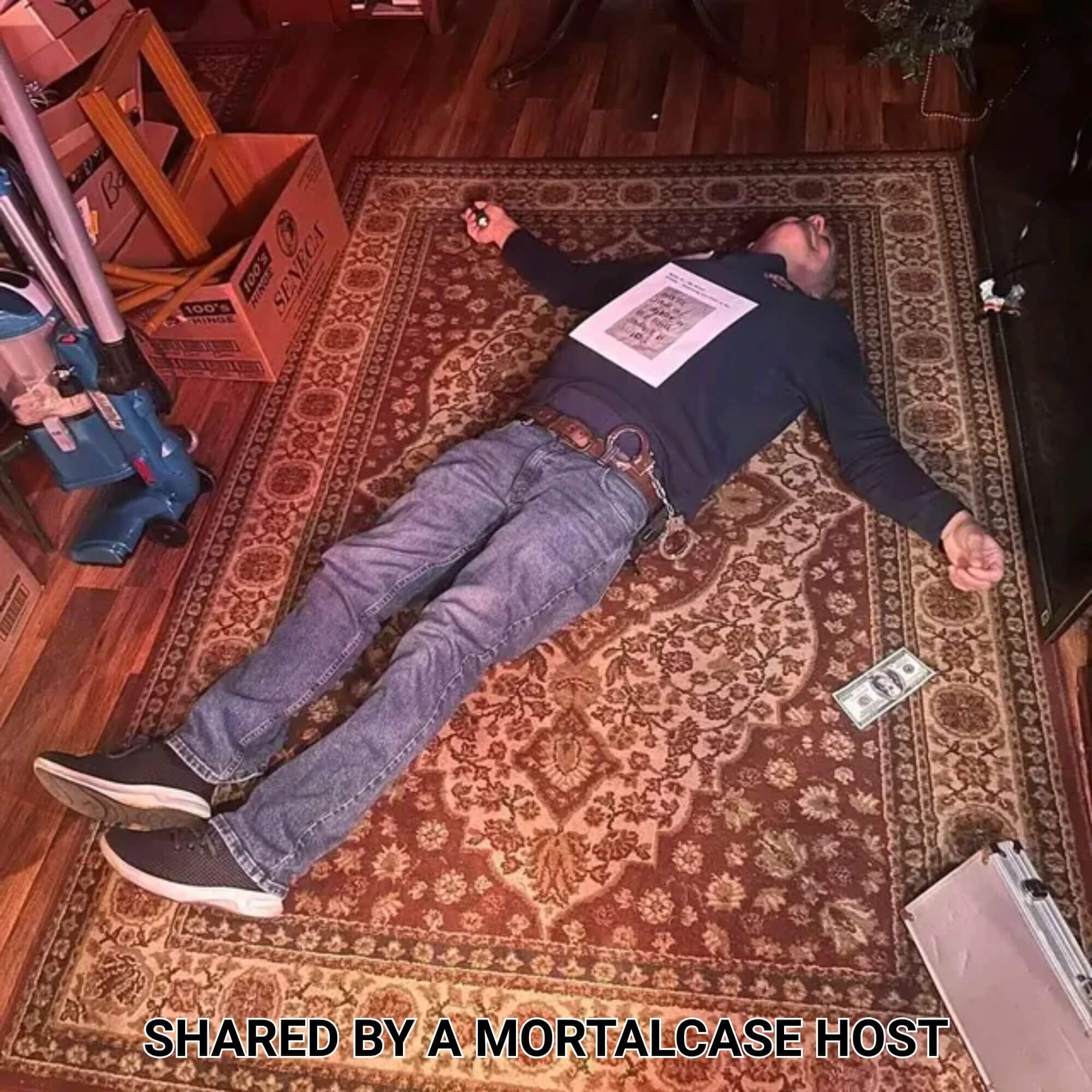 Guest posing as a murder victim with prop money and handcuffs during Casino Killer: High-Stakes Murder.